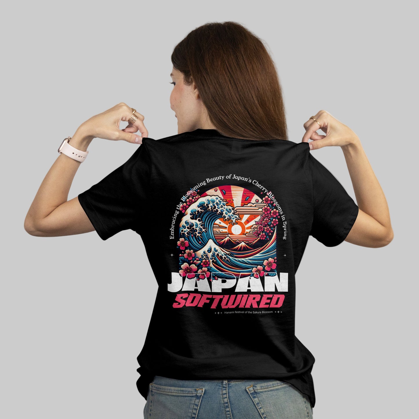 Person wearing a black t-shirt with a colorful design and 'Japan Softwired' text on the back.