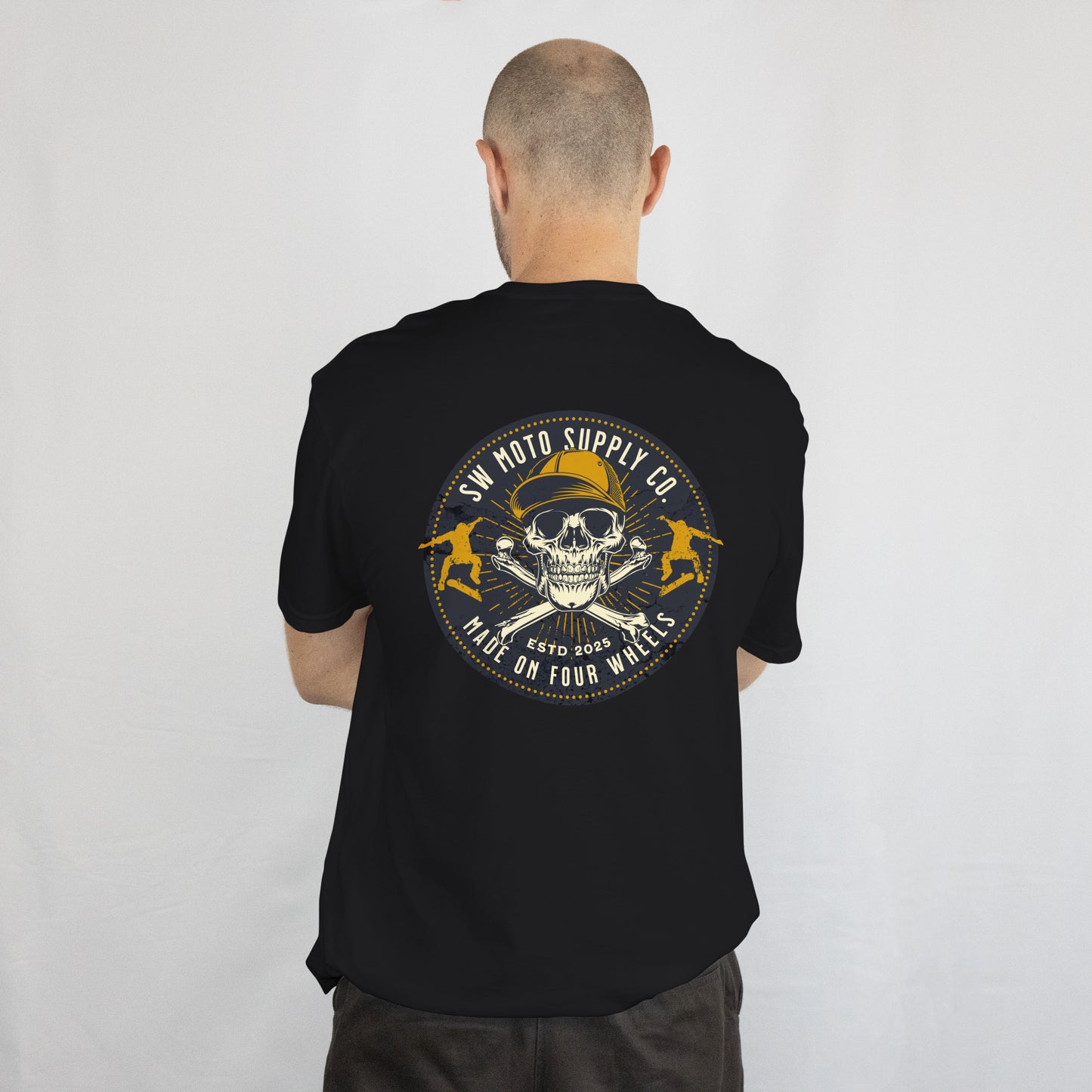 Person wearing a black t-shirt with a skull and crossbones design on the back, against a white background