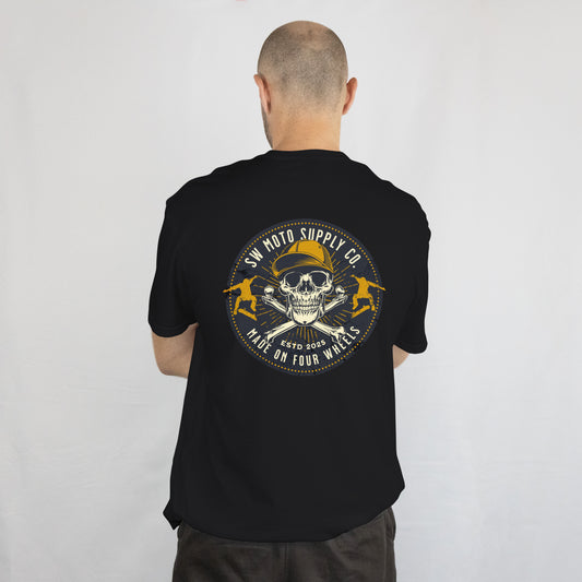 Person wearing a black t-shirt with a skull and crossbones design on the back, against a white background