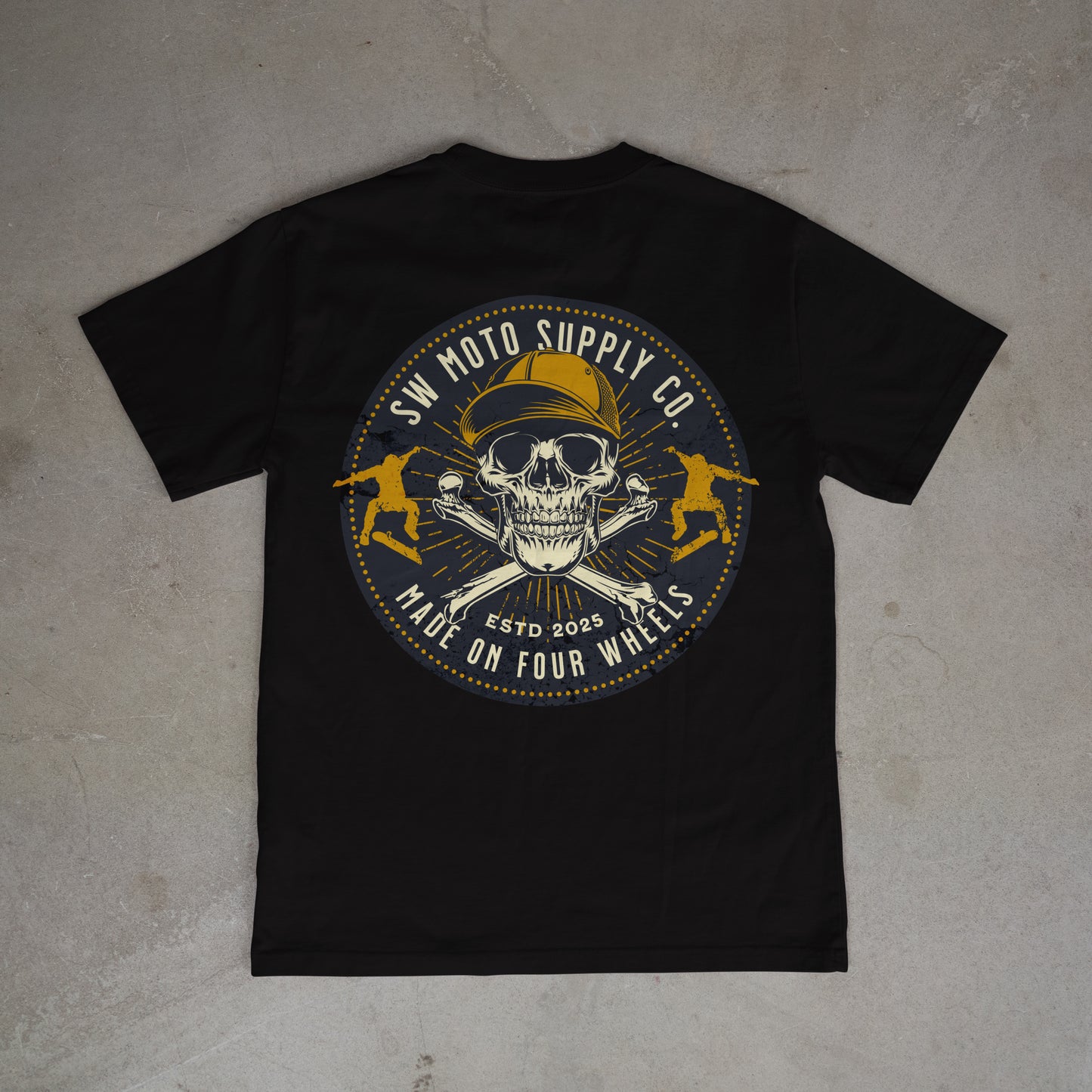 Black t-shirt with a skull and crossbones design on a gray surface