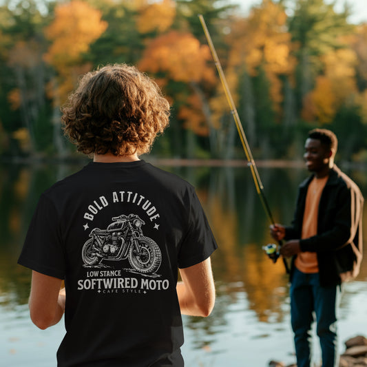 Two people by a lake with one wearing a black t-shirt with motorcycle graphic and text.